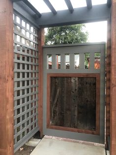 a wooden gate with lattice design on it