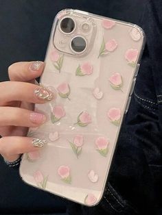 a woman's hand holding an iphone case with pink flowers on the front and sides