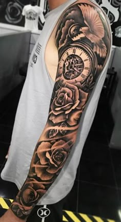 a man with a clock and roses tattoo on his arm