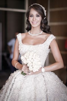 a woman in a wedding dress holding a bouquet