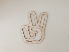 a wooden peace sign hanging on the wall