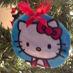 a hello kitty ornament hanging from a christmas tree