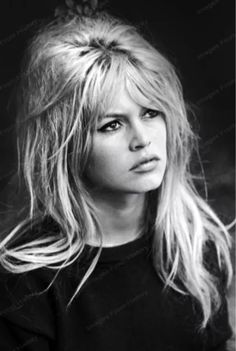 a black and white photo of a woman with long blonde hair wearing a t - shirt