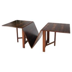 two wooden tables sitting next to each other on top of a white surface with one open and the other closed