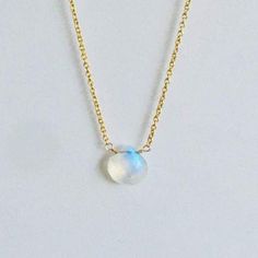 The moonstone briolette drop has a beautiful fiery, flashy blue hues. A great piece to wear every day. Delicate cable chain necklace accelerated with fiery rainbow moonstones . Length 14.5" Plain gold necklace with fiery rainbow moonstone drop. Length 17" adjustable to 16". Since ancient times it is said that Moonstone carries the energy of the new moon and enhances energies of the feminine goddess. It is claimed that holding this vibrant stone is like wearing a rainbow in your heart because of Plain Gold Necklace, Cable Chain Necklace, New Moon, Ancient Times, Moon Stone, Blue Hues, Rainbow Moonstone, Cable Chain, Moonstone