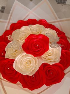 a bouquet of red and white roses on display