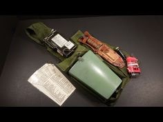 the contents of an army pouch are laid out on top of a black countertop