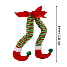 a christmas stocking hanging from the side of a wall with a red and green striped ribbon