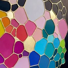 a close up view of a multicolored stained glass window