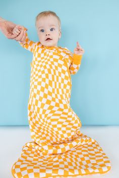 Get your sleep on with our Sunshine Wave Checks Dream Sleep Sack! Made with bamboo material, this sleep sack will have you drifting off to dreamland in no time. The playful sunshine wave checkers pattern adds a touch of whimsy to your slumber. Our ultra soft Dream sleeveless sleep sacks will be your babes go-to! Created with a double zipper for those late night diaper changes. Our Dream sleep sacks are the safest transition from swaddling featuring extra length and comfort for your little one. A Dream Sleep, Tuxedo Accessories, Toddler Flower Girls, Late Night Diapers, Girls Gloves, Toddler Flower Girl Dresses, Infant Flower Girl Dress, Bamboo Material