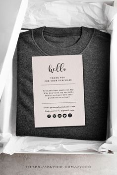 a t - shirt in a white box with a thank card on the front and back