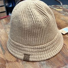 Light Brown C.C Bucket Hat Knit Texture Adjustable Strap For The Perfect Fit Authentic C.C Brand And Quality 100% Cuddly Warm Acrylic Beige Soft Knit Hat One Size, Beige Crochet Hat For Fall, One Size Fits Most, Beige Soft Knit Crochet Hat For Fall, Beige Soft Knit Hat, Cozy Beige Knit Crochet Hat, Cozy Beige Crochet Knit Hat, Fall Beige Crochet Hat, Beige Knit Crochet Hat For Fall, Beige Crochet Knit Hat For Fall