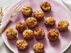 a pink plate topped with mini muffins next to a fork and silverware