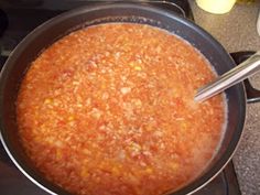 a pot filled with chili sitting on top of a stove