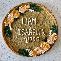 a cake decorated with flowers and the words i am isabella 11 / 22