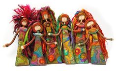 three dolls are standing next to each other with long hair on their heads and hands