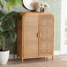 a wicker cabinet next to a potted plant