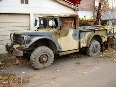 an old truck parked in front of a house