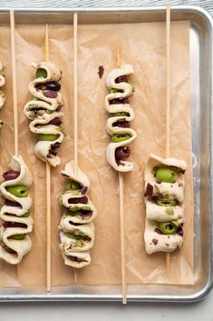 several skewered food items are on a baking sheet and ready to be eaten