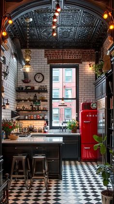 the kitchen is decorated in black and white checkerboard flooring with red refrigerator