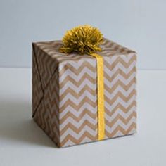 a brown and white gift box with a yellow ribbon