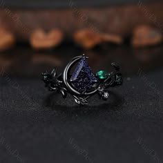 Nature inspired blue sandstone engagement ring set unique moon style emerald cluster ring gothic black gold rings for women leaf branch rings -----Ring Information----- ✦Engagement Ring Metal Type: 925 sterling silver, 10K/14K/18K Solid Gold, Platinum Center stone: Blue sandstone Stone size: 7x10mm kite cut Side stone: emerald ✦Wedding Band Stone: Round amethyst  ✦ Please feel free to contact me if you have any questions or you are interested in custom order. ✦Black rhodium plating: Rhodium, a v Sapphire And Garnet Ring, Black Gold Wedding Rings Sets, Moon Engagement Ring Silver, Bismuth Engagement Ring, Blue Sandstone Engagement Ring Silver, Witch Wedding Ring, Gothic Promise Rings