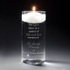 a candle that has been placed in a glass with the words, this light shines as a symbol of life and love remembrance