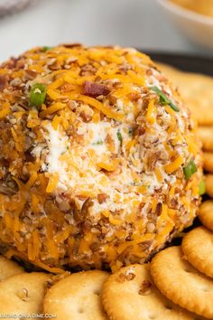 cheese ball on top of crackers with green onions