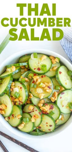 a white bowl filled with cucumber salad next to chopsticks