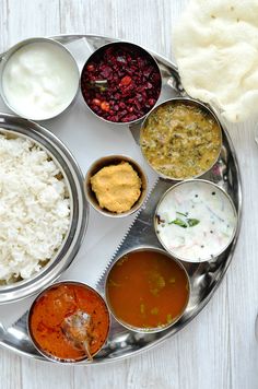 a silver plate topped with different types of food