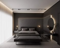 a large bed sitting in the middle of a bedroom next to a wall mounted mirror