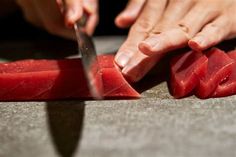 a person cutting up some food with a knife