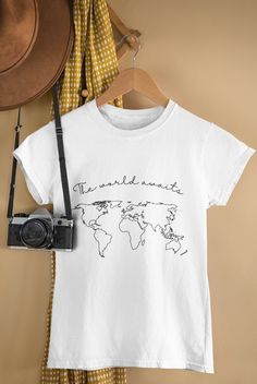 Get ready to be OBSESSED with your new The World Awaits travel shirt. Great as a birthday, holiday, Mother's Day, for the travel obsessed, or just because gift! This classic unisex jersey short-sleeve tee fits like a well-loved favorite. Soft cotton and quality print make users fall in love with it over and over again. These t-shirts have ribbed knit collars to bolster shaping. The shoulders are tapered for a better fit over time. Dual side seams hold the garment's shape for longer.  * Q U I C K * F A C T S * ✺ Solid colors are 100% cotton except Ash - 99% cotton and 1% polyester. Heather colors and Solid Black Blend are 52% cotton, 48% ployester, (Athletic Heather and Black Heather are 90% cotton and 10% polyester) ✺ Side seams: located along the sides, they help hold the garment's shape Travel Shirt, Just Because Gifts, Travel Shirts, Solid Black, Print Making, Solid Colors, Mother's Day, Ribbed Knit, Print Quality