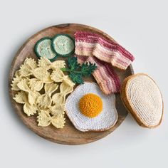 an image of food that is on a plate with bread and vegetables in the shape of eggs