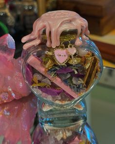 a glass vase filled with lots of different items