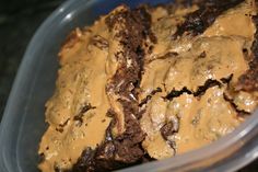 a plastic container filled with brownies covered in peanut butter