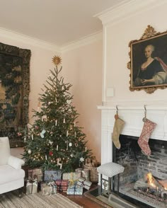 a living room with a christmas tree and fireplace