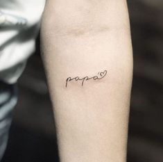 a person with a tattoo on their arm that says papao in cursive writing