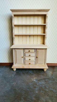 a white wooden cabinet sitting on top of a floor