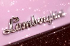 an image of the name land rover written in shiny silver letters on a pink background