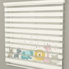 an animal themed window blind with zebras, giraffes and elephants on it