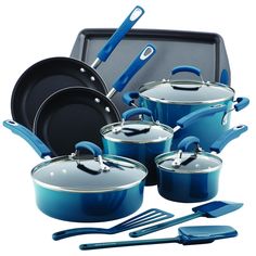 an assortment of pots and pans with blue handles