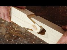 a man is working on a piece of wood that has been cut into smaller pieces