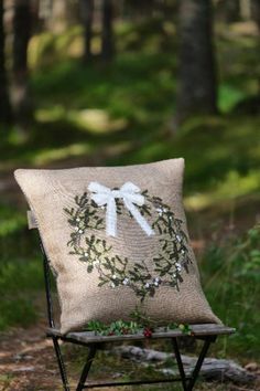 a chair with a pillow on it in the woods