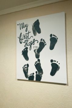 a sign that says my first steps with footprints on it