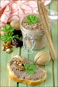 some bread and nuts on a table with a jar of nut butter next to it