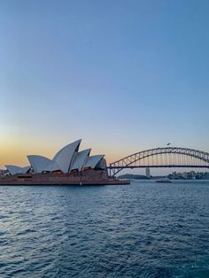 the sydney opera house and harbour bridge at sunset