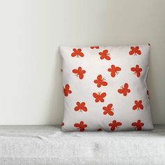 a white pillow with red flowers on it