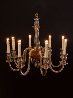 a chandelier with many lit candles in it