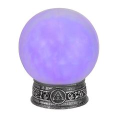 a purple ball sitting on top of a metal stand